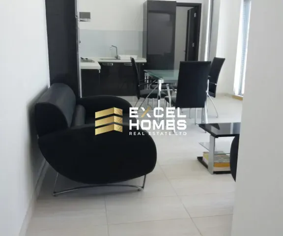 a living room with a couch, chair, and a television