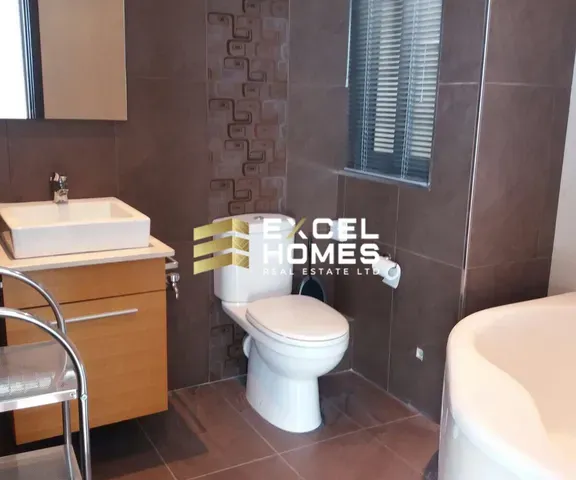 a white toilet sitting next to a sink in a bathroom