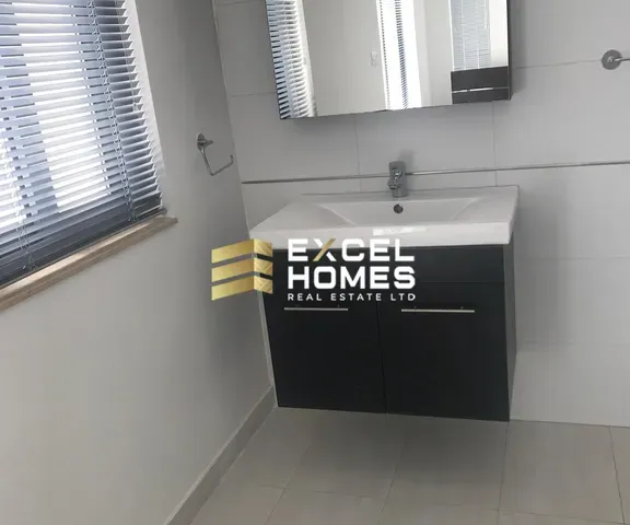 a white toilet sitting next to a window