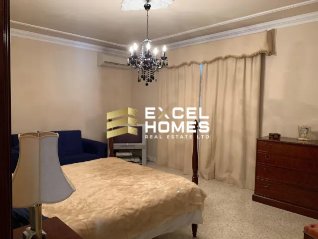 a bedroom with a bed, a lamp and a window