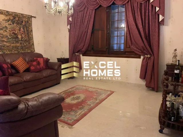 a living room with a couch, coffee table and a television