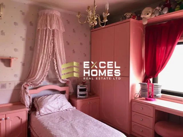 a bed with a pillow and a window
