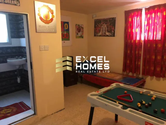 a room with a tv and a rug
