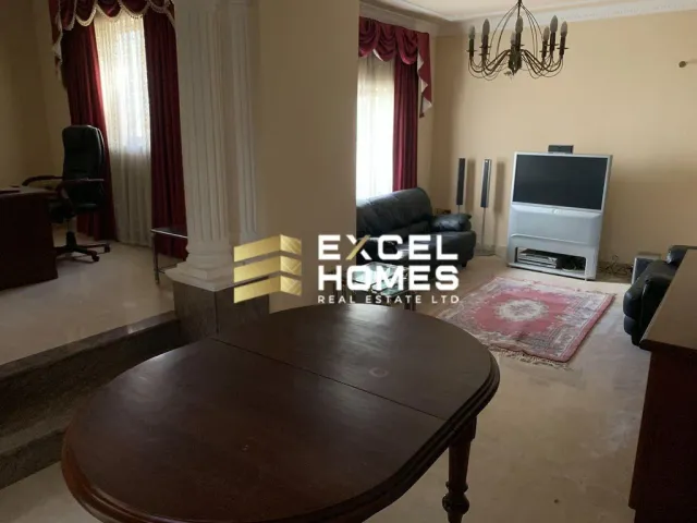 a living room with a television and a table
