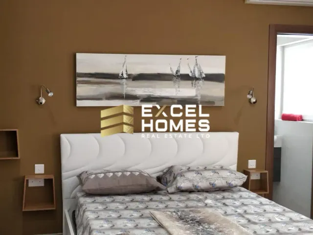 a bed with a white bedspread and a white wall