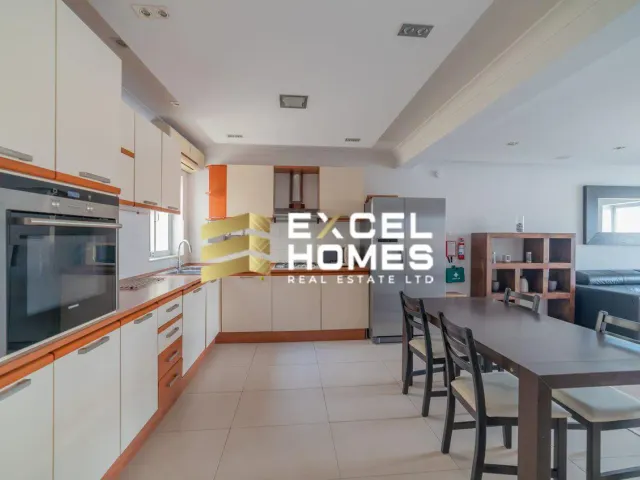 a kitchen with a stove, microwave, refrigerator and a table