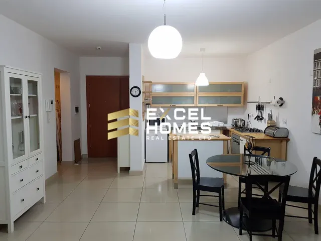 a kitchen with a table and chairs and a refrigerator