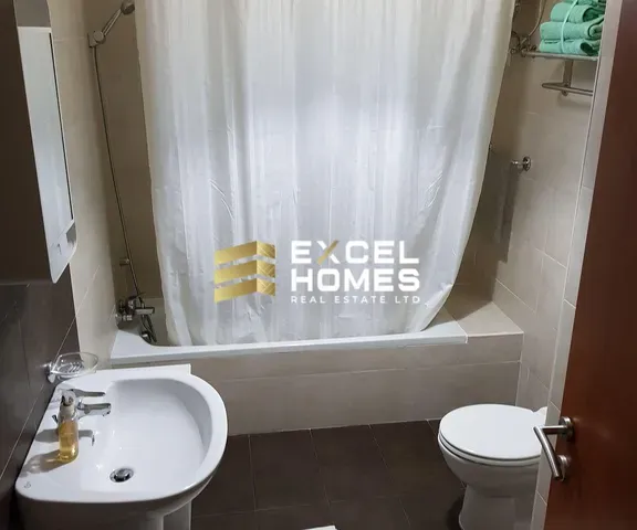 a bathroom with a toilet and a bath tub