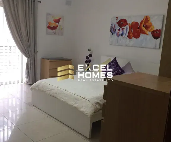 a bedroom with a bed, a lamp, and a window