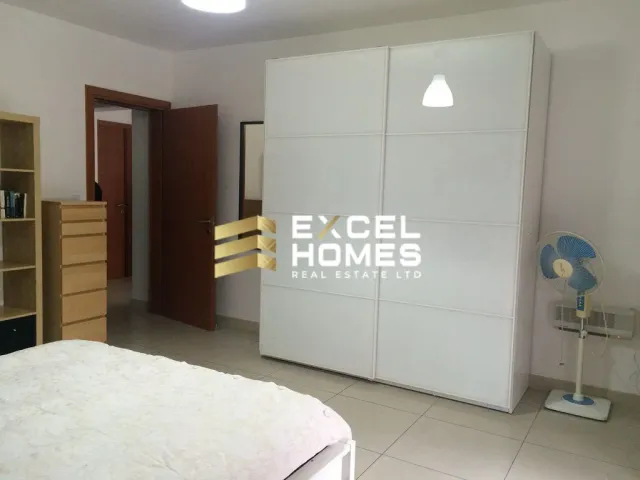 a bedroom with a bed, a dresser and a mirror