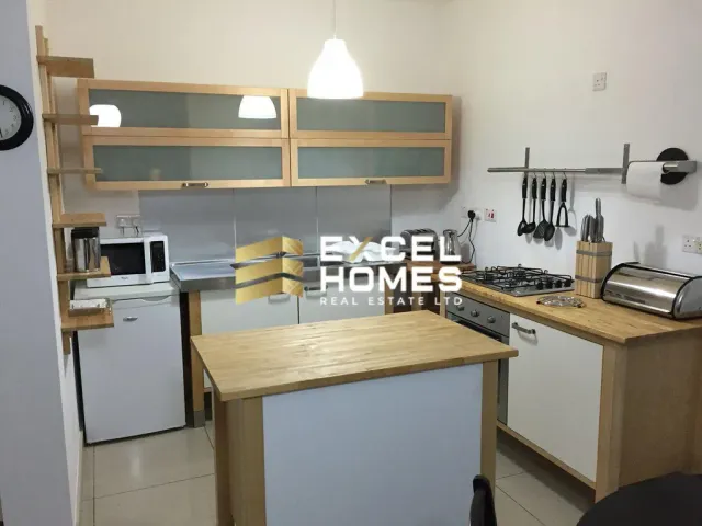 a kitchen with a stove, microwave, refrigerator and a sink