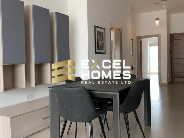 a kitchen with a table and chairs and a refrigerator