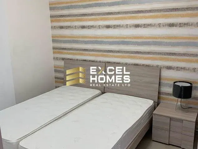 a bed with a white bedspread and a white comforter