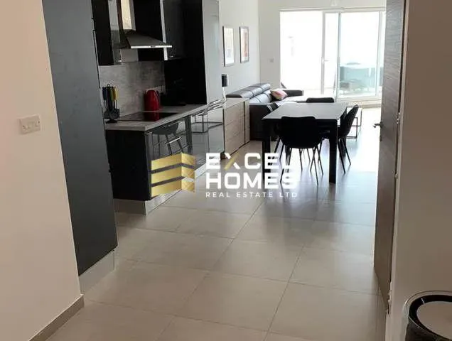 a kitchen with a white refrigerator and a black counter