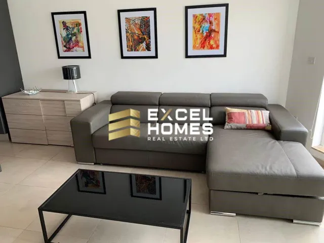 a living room with a couch, coffee table, and a television