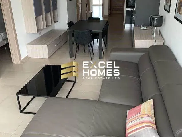 a living room with a couch, coffee table and a television