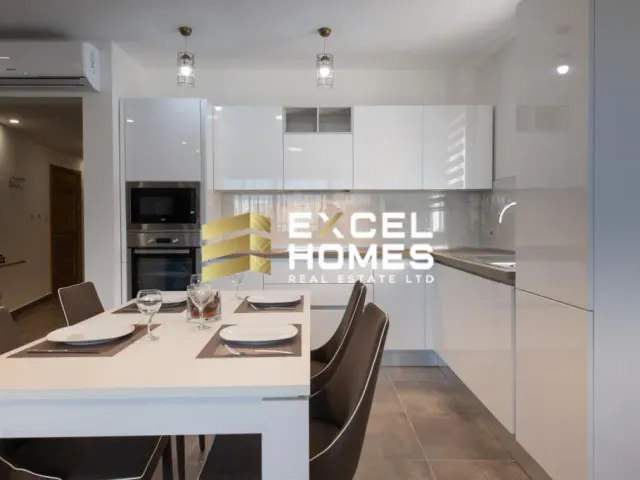 a kitchen with a white counter top and a white refrigerator