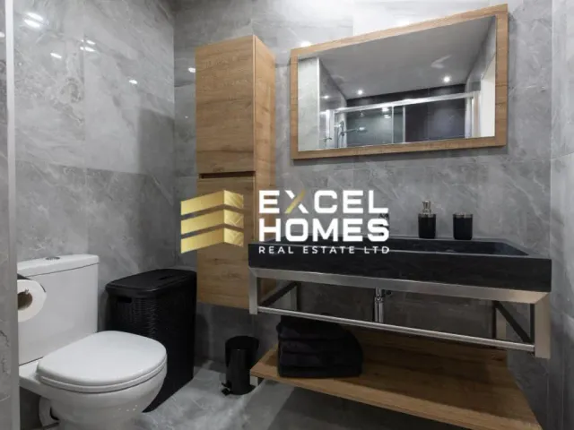 a bathroom with a toilet, sink, and a mirror