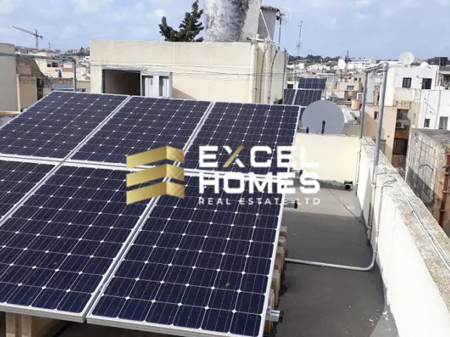 a large white building with a blue sky