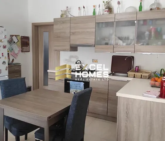 a kitchen with a table and chairs and a refrigerator