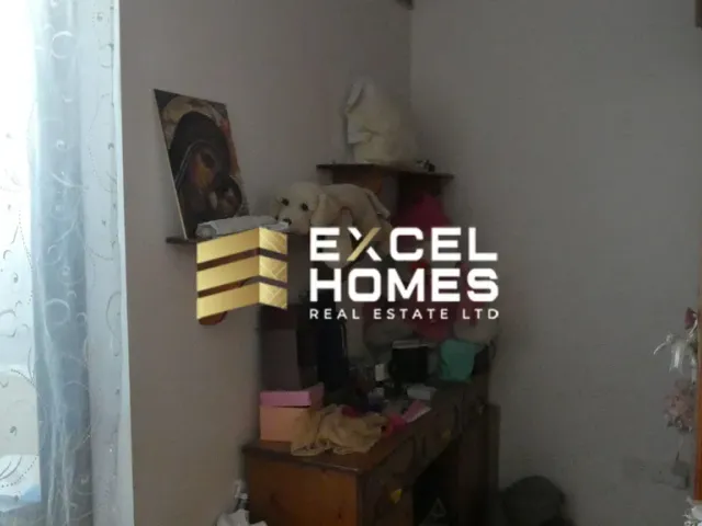 a room with a book shelf and a lamp