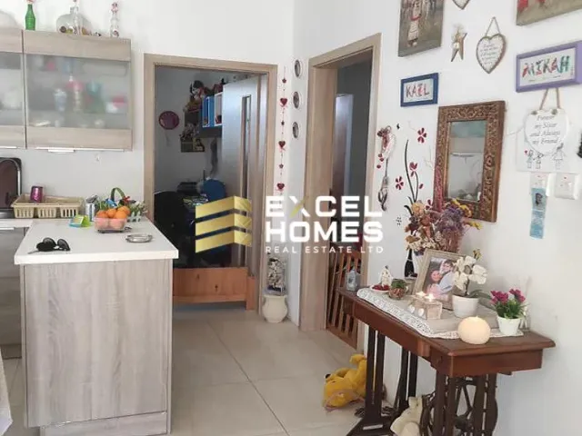 a kitchen with a sink, a refrigerator, and a table