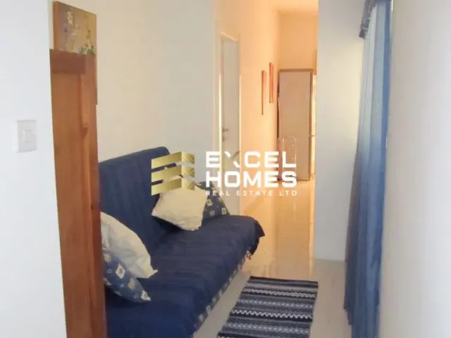 a couch and a dog on a rug