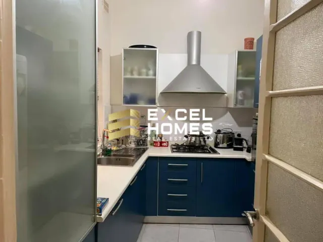 a kitchen with a refrigerator, stove, and a counter 
