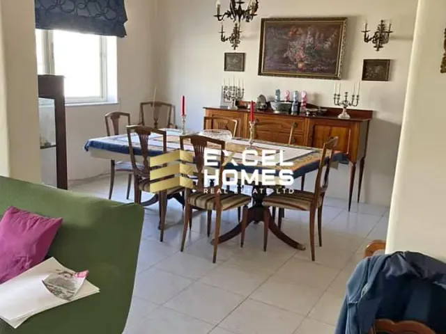 a living room with a table and chairs 