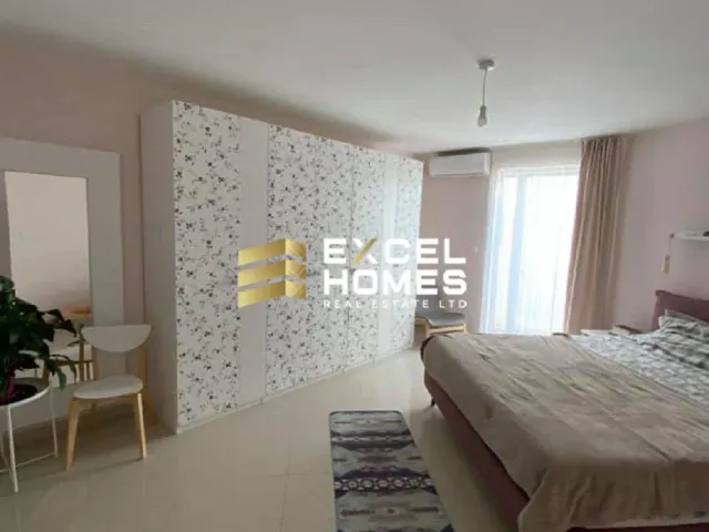 a bedroom with a bed, a dresser, and a lamp