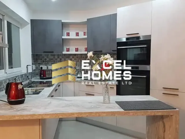 a kitchen with a sink, stove, and refrigerator