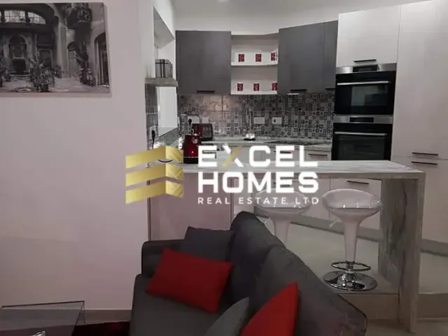 a living room with a couch, coffee table, and a television