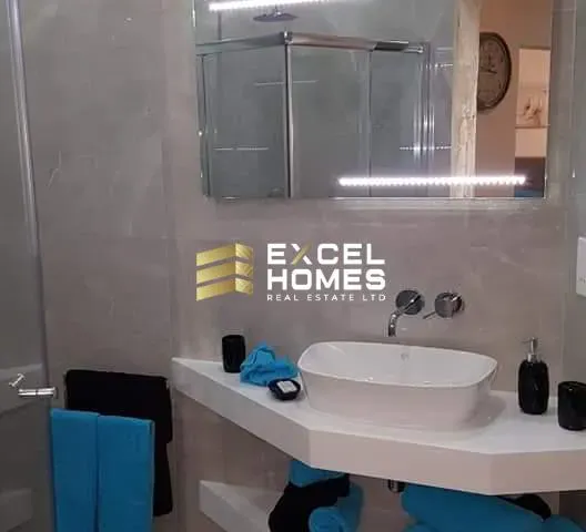 a bathroom with a sink, mirror, and a bath tub