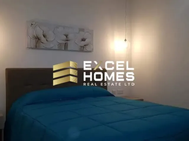 a bed with a blue and white bedspread and a blue and white night stand