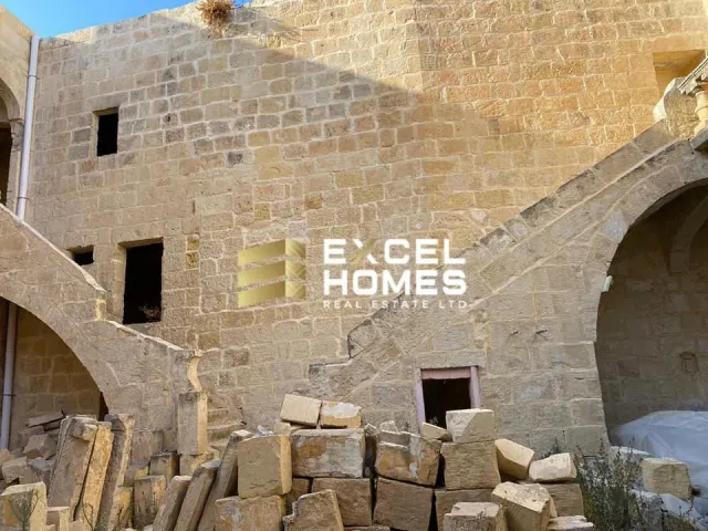 a stone wall with a stone wall and a stone wall with a clock