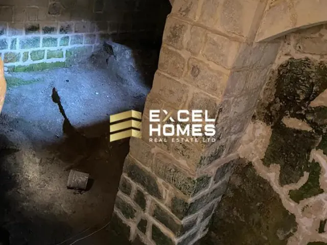 a man walking down a street next to a wall