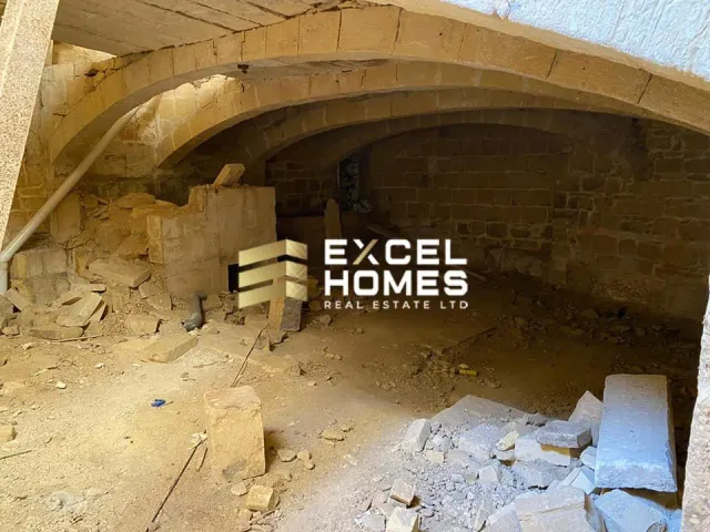 a wall with a stone wall and a tunnel