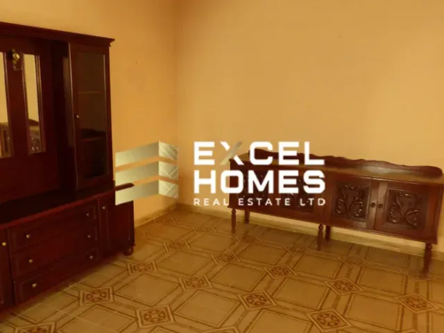 a room with a wooden floor and a wall with a picture of a man on it