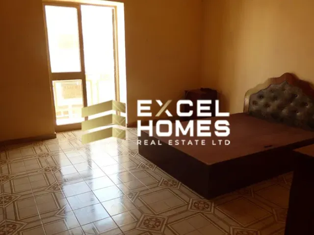 a room with a bed, a desk and a window