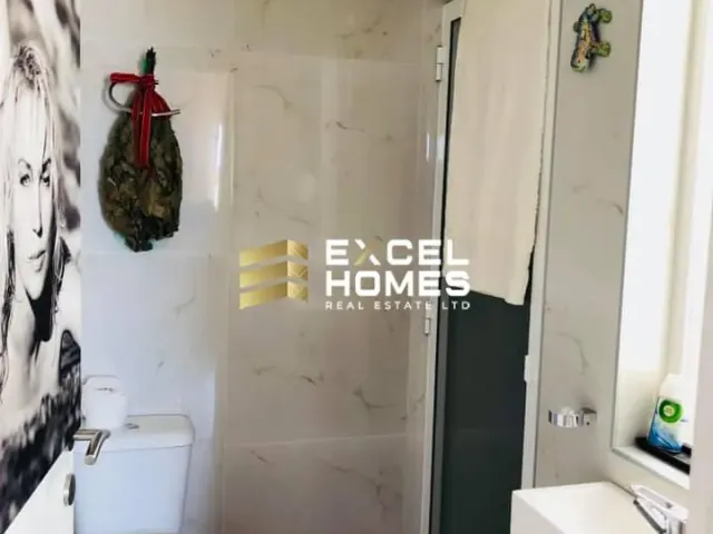 a bathroom with a shower stall and a toilet 