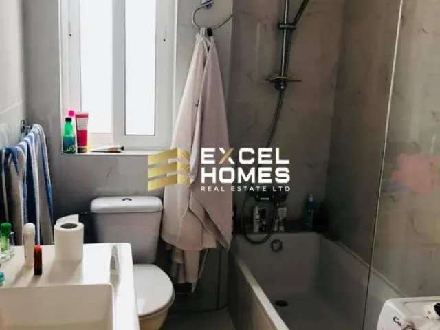 a bathroom with a toilet, sink, and shower 
