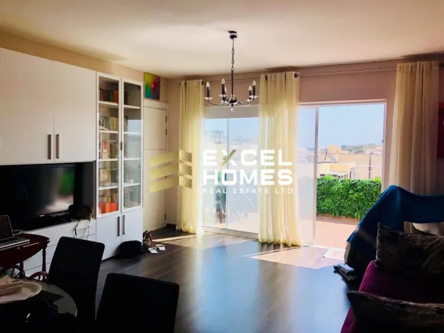 a living room with a tv and a window 