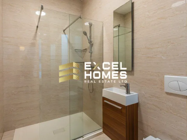 a bathroom with a shower, toilet, sink and a mirror 