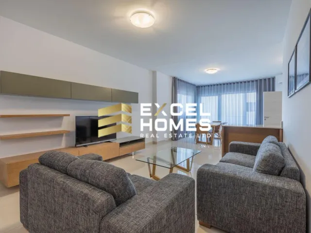 a living room with a couch, coffee table and a television 