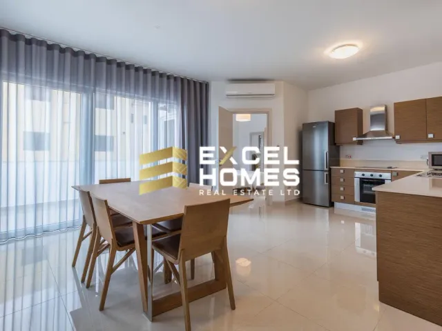 a kitchen with a table, chairs, and a refrigerator 