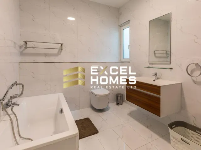 a bathroom with a tub, sink, and toilet 