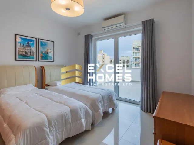 a bedroom with a bed, a mirror and a window 