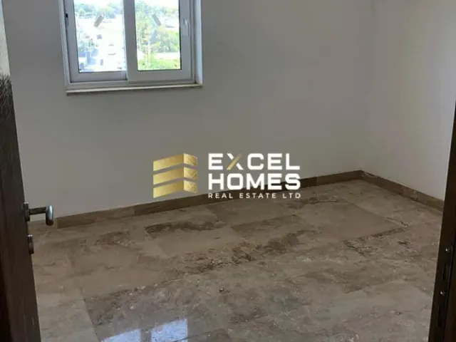 a room with a toilet and a wall with a rug