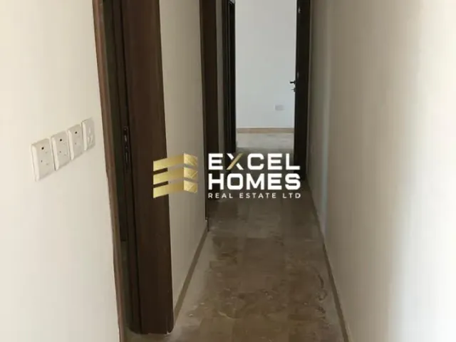 a person standing in a hallway with a door open