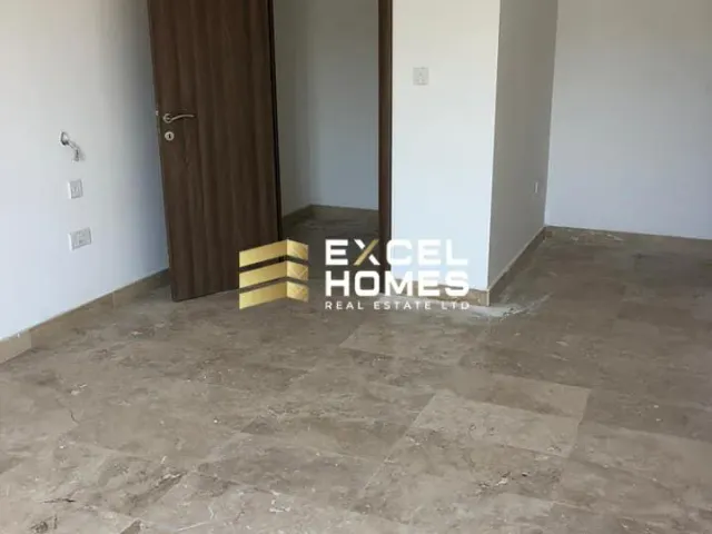 a room with a chair and a wall with a rug